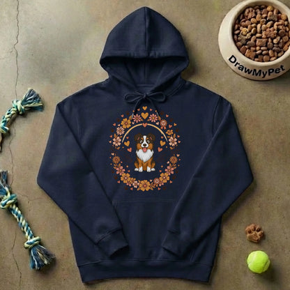 Pull à capuche gris avec motif "Liés pour la vie" et illustration de chien, plié à côté d'une gamelle de croquettes et une balle de tennis, suggérant un foyer avec un animal.