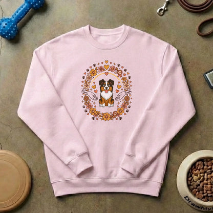 Detalle del diseño floral con un perro de raza Australian Shepherd sonriente y nombres personalizados en el suéter.