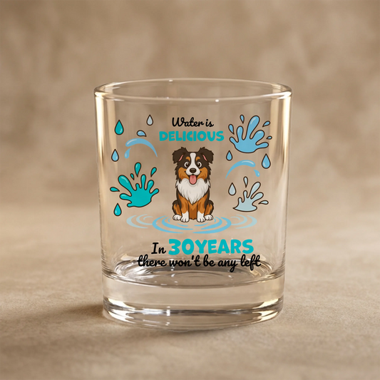 Personalized glass with happy cartoon dog and 'Water is delicious' slogan.