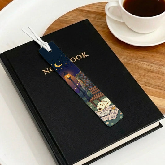 Personalized Starry Night leather bookmark with a sleeping yellow dog on an open book, next to a coffee cup.