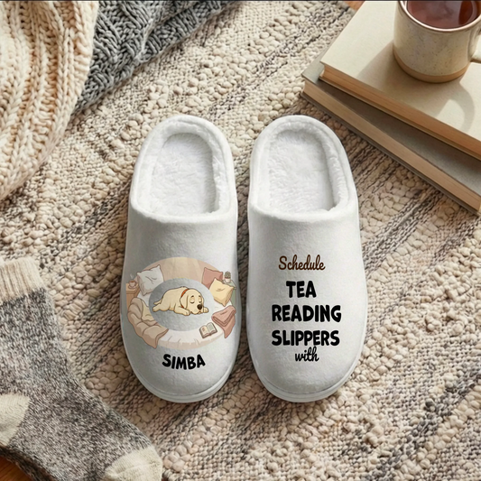 Personalized slippers with 'Schedule TEA READING SLIPPERS with' design and a sleeping dog illustration.