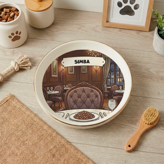 Personalized cat bowl with 'Fine Dining Restaurant' design and custom name 'Simba', filled with kibble on a wooden floor.