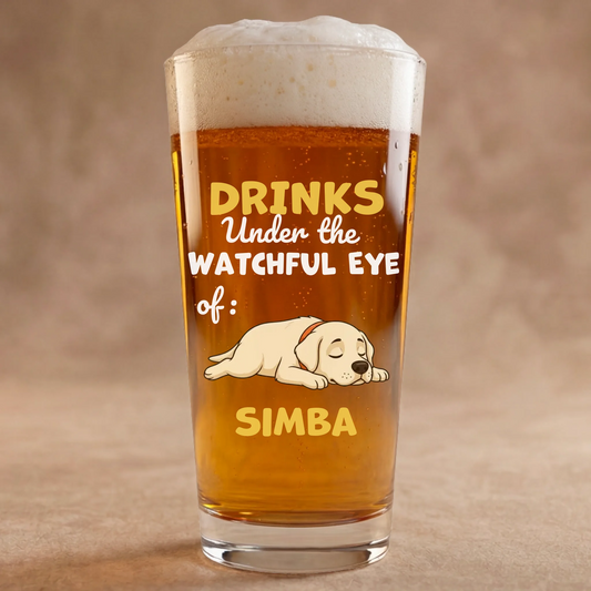Personalized beer glass with a sleeping Labrador puppy and "Drinks Under the Watchful Eye of" slogan.