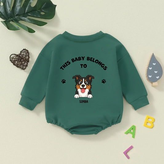 Personalized green baby bodysuit with 'This Baby Belongs To' text and a happy dog portrait, celebrating pet-baby bond.