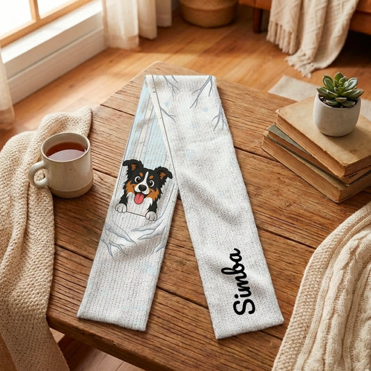 Personalized "First Snowfall" dog scarf on cozy wooden table.