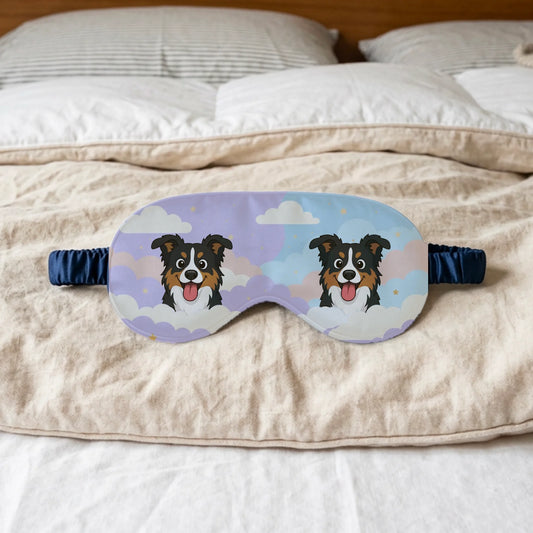 Personalized sleep mask with two happy cartoon dogs peeking from clouds, lying on a cozy bed.